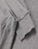 A grey long-sleeve tee shirt with a soft fabric and cuffed sleeves, featuring a logo on the side.