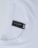 A white long-sleeve tee with a round neckline, featuring a label and a logo.
