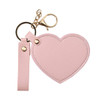 A pink heart-shaped compact mirror with a gold keychain attachment. Includes a strap for easy carrying.