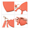 A heart-shaped compact mirror in orange with a keychain attachment, featuring a gold clasp and strap.