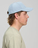A light blue Jacquard Texture 5 panel cap worn by a young man with a beige shirt, showcasing a side profile view.