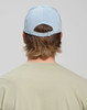A light blue Jacquard Texture 5 Panel Cap seen from the back, featuring an adjustable strap and a logo.