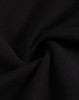 A close-up view of black fleece fabric, showcasing its soft texture and smooth finish.