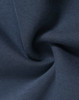 A close-up of soft, navy fleece fabric, showcasing its texture and smoothness, with a logo visible.
