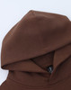 A brown unisex premium fleece oversized hoodie featuring a large hood and a logo.