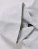 A grey oversized hoodie featuring a hood and a label inside, with a soft fleece texture.