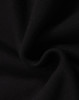 A close-up of black fleece fabric, showcasing its soft texture and smooth finish, with a logo present.