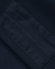 A close-up of a navy fleece fabric with a textured patch, featuring an area for branding or labels.