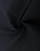 A close-up of dark fabric, showcasing the texture of a cotton blend material in black.