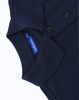 A navy blue men's classic cotton/poly pique short sleeve polo with a collar and buttons. Features a logo.