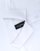 A white ultrafine cotton pique polo with a folded collar and a branding label visible inside.