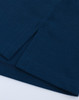 A close-up of a navy ultrafine cotton pique polo, featuring textured fabric and clean hems.