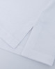 A close-up of a white ultrafine cotton pique polo, featuring textured fabric and neatly folded hems.