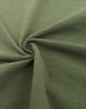 A close-up of a green fabric, showcasing its texture and softness, with a circular twist pattern.