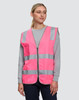 A pink high-visibility safety vest with reflective stripes and utility pockets, worn by a model.