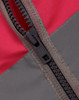 A close-up of a zippered section of a hi-vis vest, featuring a red and grey colour scheme with a utility pocket.