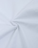 A close-up of white fabric, showcasing its heavy cotton texture and smooth surface. The fabric is gathered in a swirl.