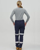 A pair of navy work pants with reflective tape, worn with a grey long-sleeve shirt, seen from the rear.
