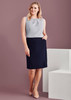 A woman wearing a light grey top and a navy straight skirt with front pleat details, posing against a neutral background.