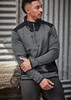 A grey and black unisex pullover with a 1/2 zip and a logo, set against a textured background.