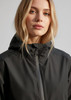A black women's rain jacket with a hood, featuring a zip closure and a simple, sleek design.