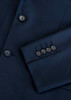 A navy blue jacket featuring a sleek design and buttoned cuffs, with a subtle logo present.