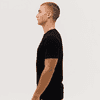 A black t-shirt is displayed on a model, shown from the side profile against a plain background.