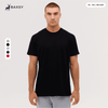 A black T-shirt featuring a classic fit, with a logo present, displayed on a model against a neutral background.