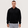 A black zip-up hooded sweatshirt on a model, featuring a front zipper and drawstring hood.