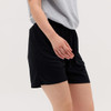 Black Core Shorts featuring an elastic waistband, shown worn with a grey top.