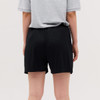 Black shorts showcased on a model from a rear view, featuring an elastic waistband and a smooth fabric texture.