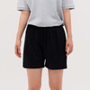 Black shorts displayed on a person, paired with a grey shirt, featuring an elastic waistband.