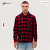 A long sleeve flannel shirt in red and black check pattern, featuring a pocket and a logo.