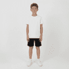 Youth Core Shorts in black, worn by a boy in a plain white t-shirt and white sneakers, standing against a plain background.