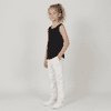 A youth singlet in black, styled with white pants and white shoes, featuring a logo.