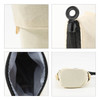 A cream canvas expandable pencil case featuring a zip closure and an attached loop for easy carrying.
