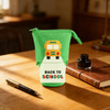 A green expandable pencil case featuring a school bus design and the text "Back to School," placed on a wooden desk.