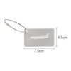 A brushed aluminium luggage tag in silver with a plane silhouette cut-out. Features a metal attachment cable.