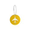 A yellow round luggage tag featuring a cut-out airplane design, secured with a metal wire cable.