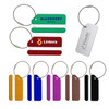 A square brushed aluminium luggage tag in silver alongside various coloured tags, including green, red, yellow, and blue.