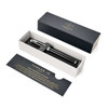 A black rollerball pen in a stylish box, featuring a sleek design and a brand logo.