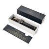 A rollerball pen in lacquer black with gold trim, presented in a stylish box with a branding logo.