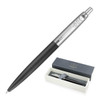 A ballpoint pen featuring a matte black finish and metallic detailing, presented in a two-tone box with a logo.
