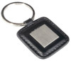 A square keyring with a metal centre and a black leather-look border, featuring a metal ring.