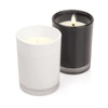 Two glass candles, one white and one black, featuring a minimalist design and a silver base.