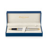 A brushed stainless steel rollerball pen with gold accents, presented in a blue gift box.