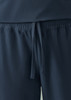 A pair of navy unisex scrub pants with an elastic waistband and drawstring detail. Features a logo.