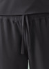A pair of black jogger scrub pants featuring an elastic waistband and drawstring tie. Logo present.