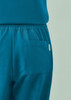 A pair of women's jogger scrub pants in teal with an elastic waistband and a side pocket.