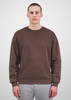 A brown crew sweatshirt for men, featuring a simple design and relaxed fit, shown on a model with grey pants.